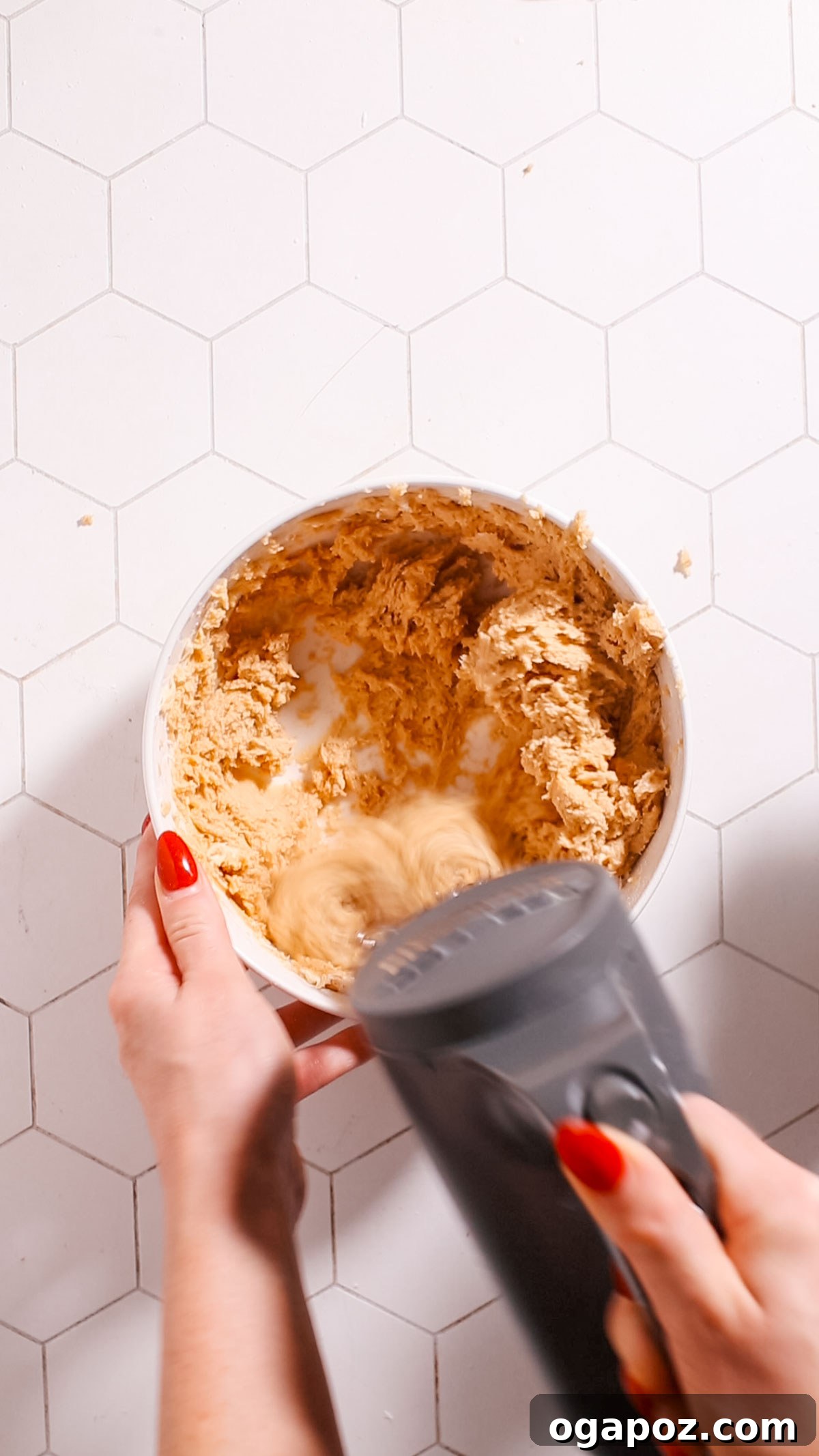 Perfectly Chewy Oatmeal and Peanut Butter Cookies 5 Creamed butter, peanut butter, and sugars in a stand mixer bowl, showing a light and fluffy texture.