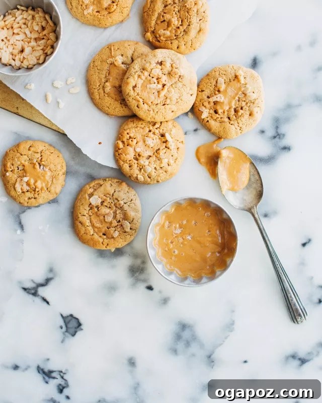 Perfectly Chewy Oatmeal and Peanut Butter Cookies 6 Freshly baked Oatmeal Peanut Butter Cookies cooling on a baking sheet.