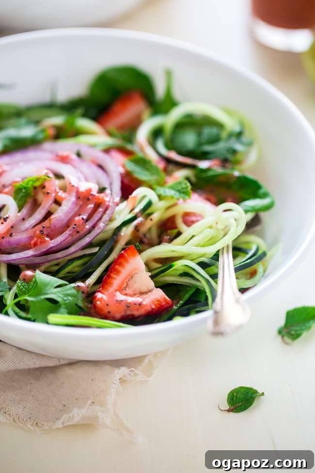 Wholesome Meals in Minutes 18 Spiralized Cucumber Salad with Chia Seed Strawberry Vinaigrette in a glass bowl.