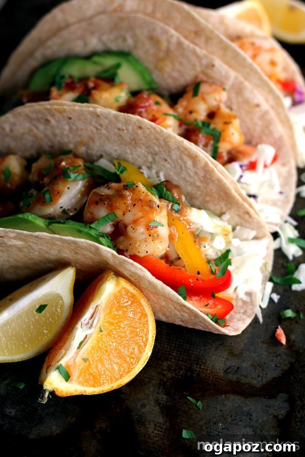 Wholesome Meals in Minutes 8 Rosemary Citrus Shrimp Tacos garnished with fresh herbs and citrus slices.