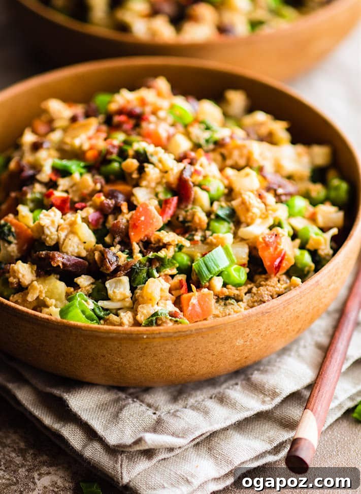 Wholesome Meals in Minutes 5 Quick Pineapple Paleo Cauliflower Fried Rice served in a bowl with chopsticks.