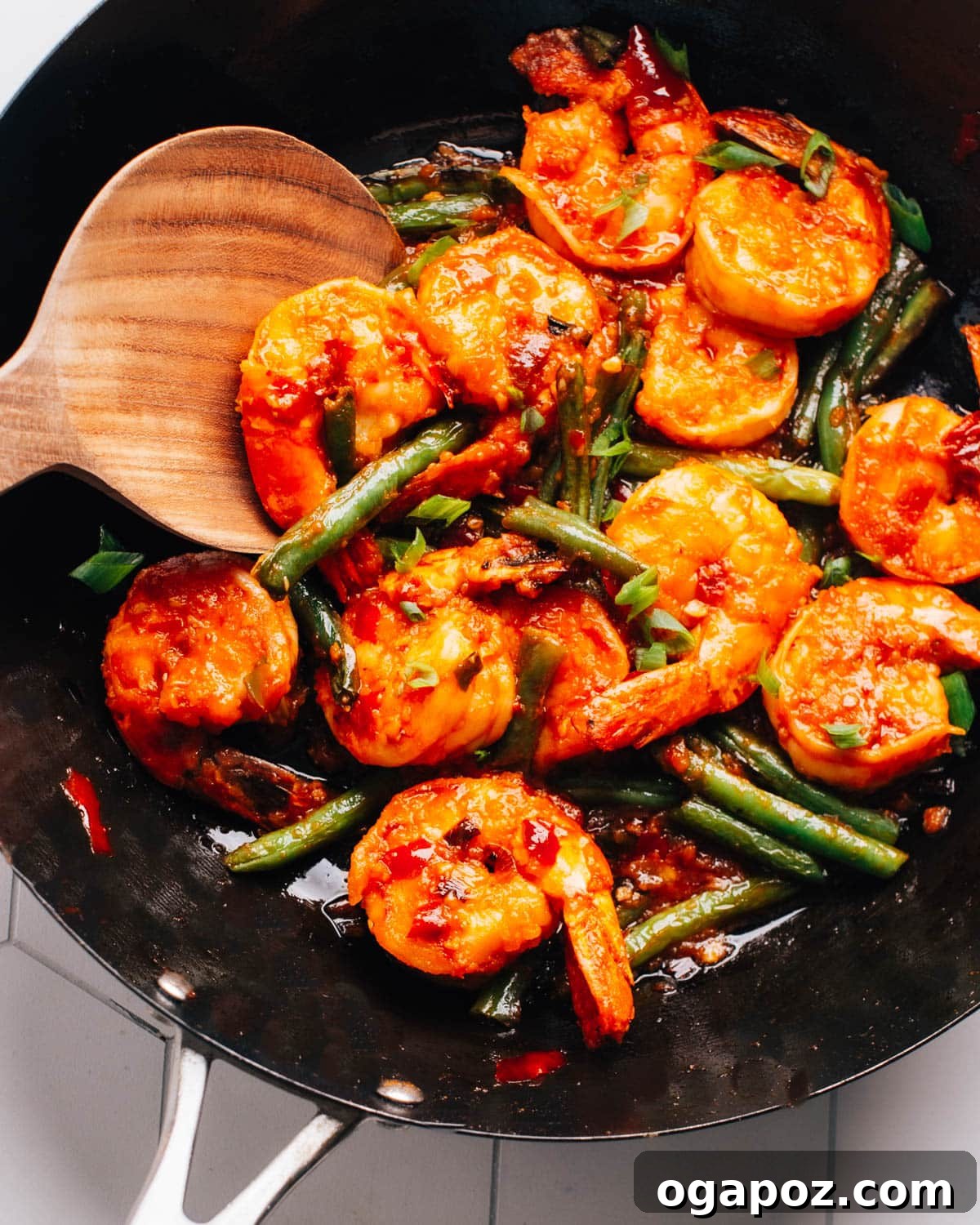 Hunan Shrimp sizzling in a wok, ready to be served hot.