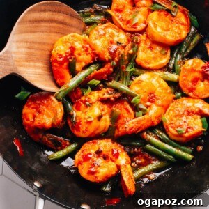 Hunan Shrimp prepared in a wok, ready to be transferred to a serving dish.