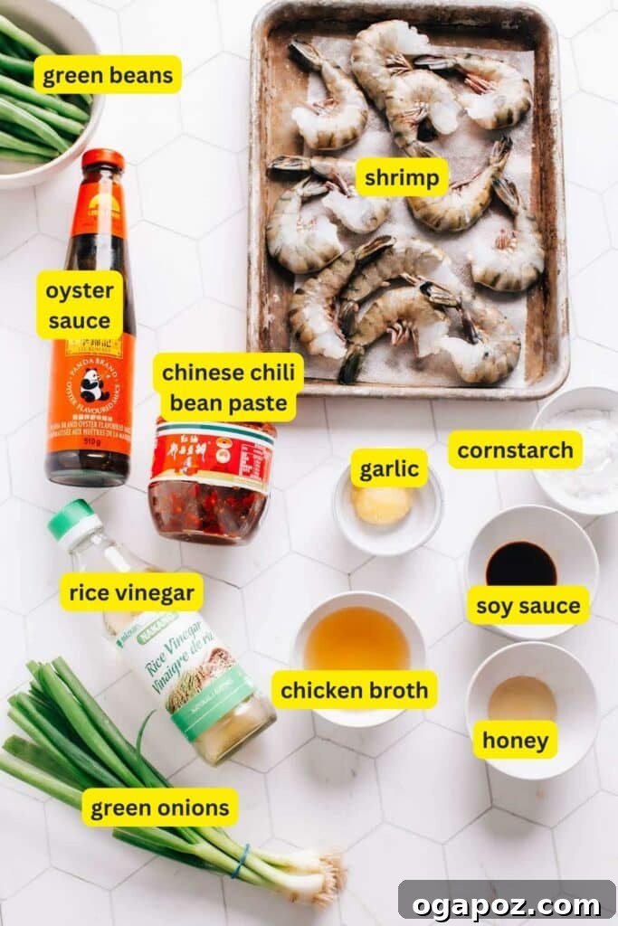 Fresh ingredients laid out for making Hunan shrimp, including raw shrimp, various vegetables, and sauce components.