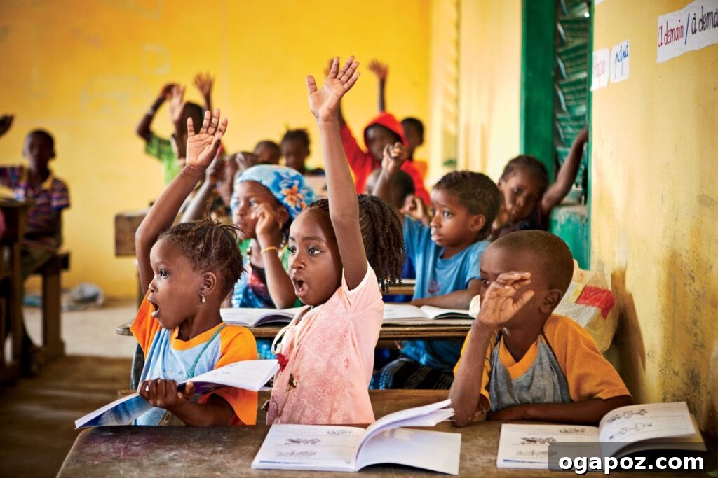Give Back, Win Big: Our Holiday Season Giveaway 3 Excited children actively participating in a lesson in a vibrant school classroom in Kandia ADP, reflecting the positive impact of World Vision's educational support.
