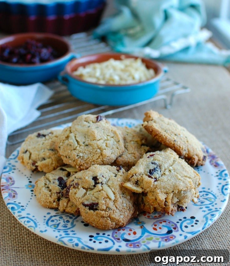 Sweet & Tart Coconut Cranberry Almond Cookies 3 Close-up of freshly baked Coconut Cranberry Almond Cookies, highlighting their delicious texture and ingredients like vibrant dried cranberries and crunchy slivered almonds. Perfect for a healthy, gluten-free, and dairy-free holiday snack.