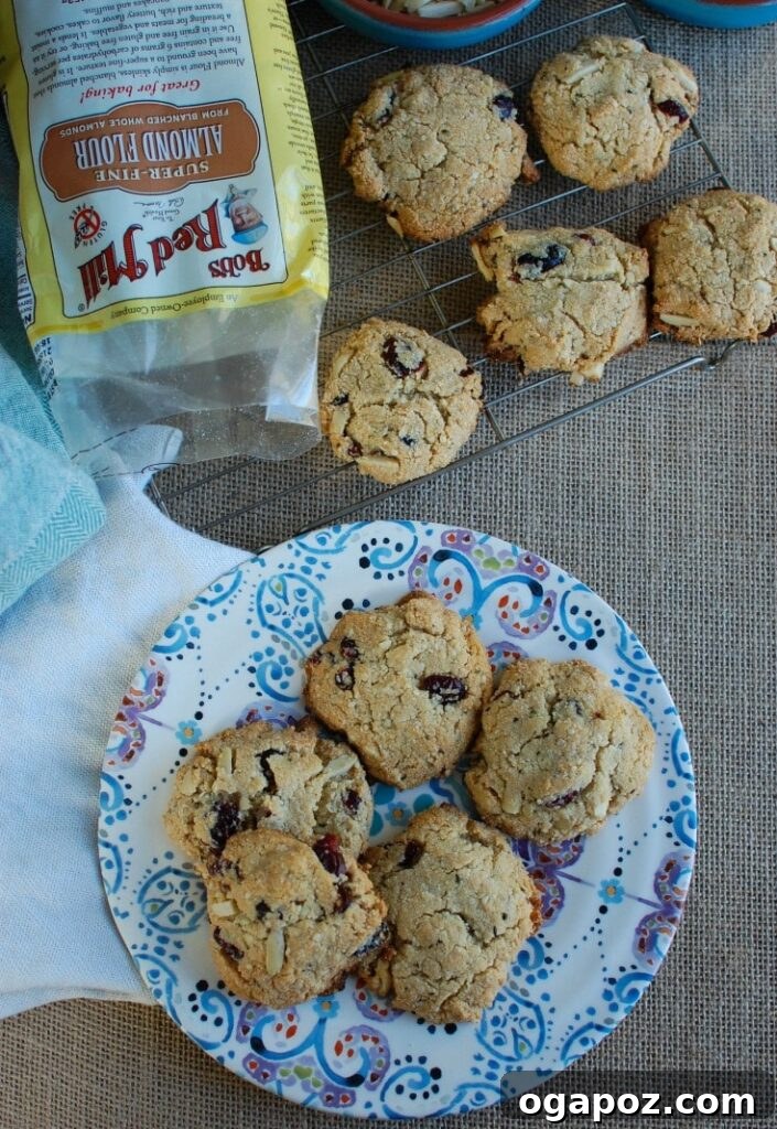 Sweet & Tart Coconut Cranberry Almond Cookies 4 A festive plate of Coconut Cranberry Almond Cookies, showcasing their golden-brown edges and vibrant red cranberries. These healthy, dairy-free, and gluten-free cookies are ideal for holiday entertaining and healthy snacking.