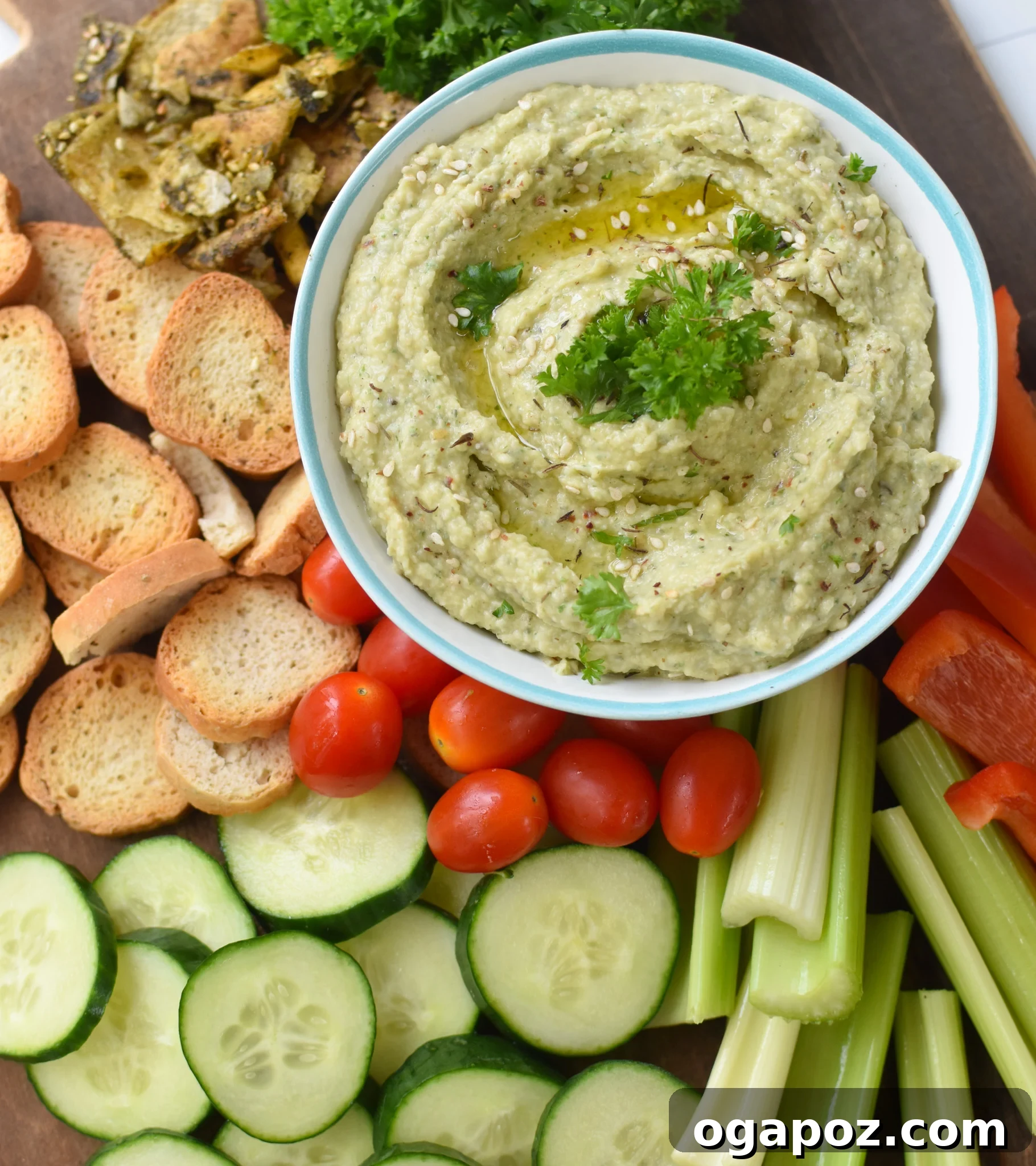 Creamy White Bean Artichoke Dip 2 Creamy White Bean Artichoke Dip served with a variety of fresh vegetables and crispy crackers.