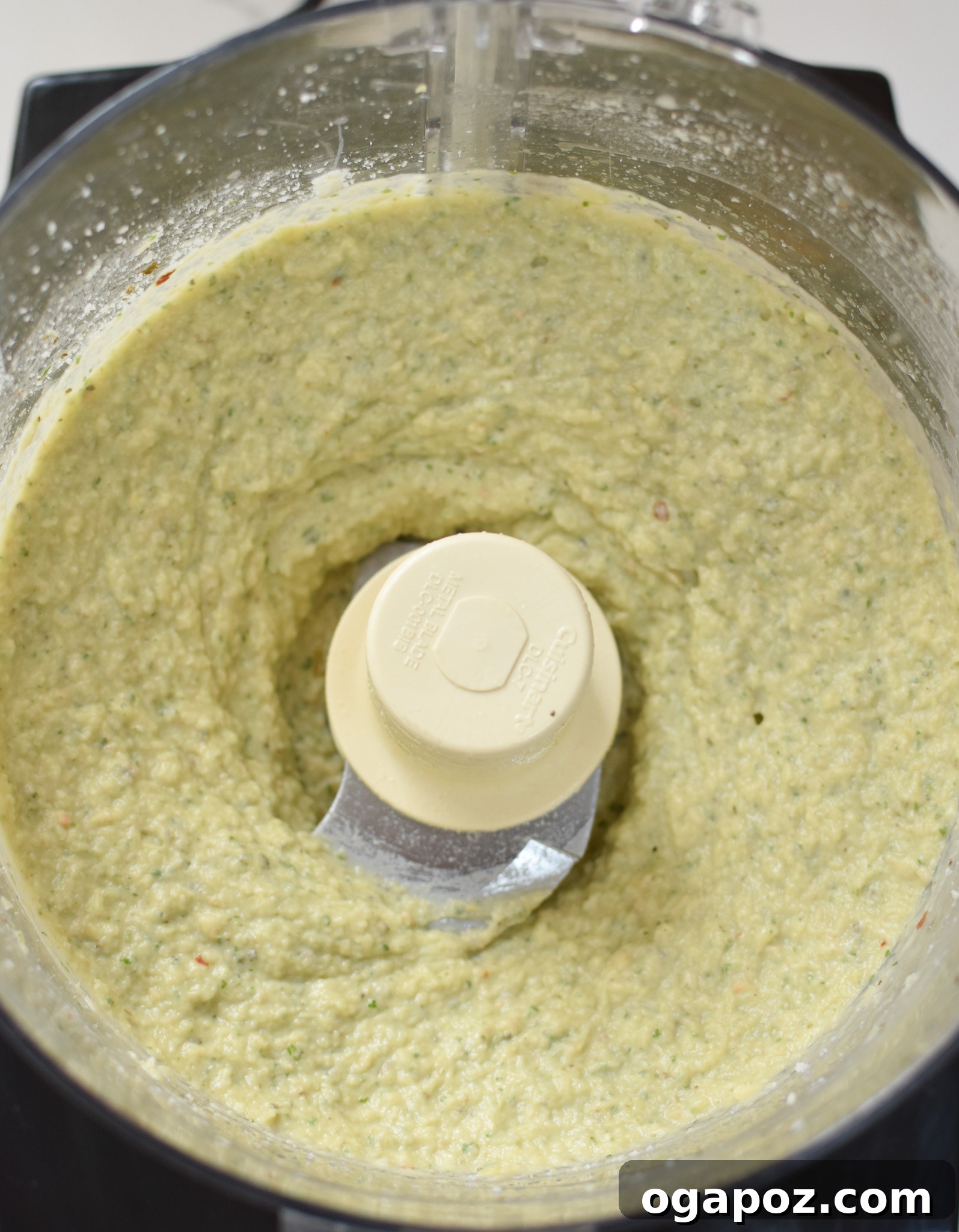 Creamy White Bean Artichoke Dip 5 A close-up of the perfectly blended White Bean Artichoke Dip in the food processor, showing its creamy texture.