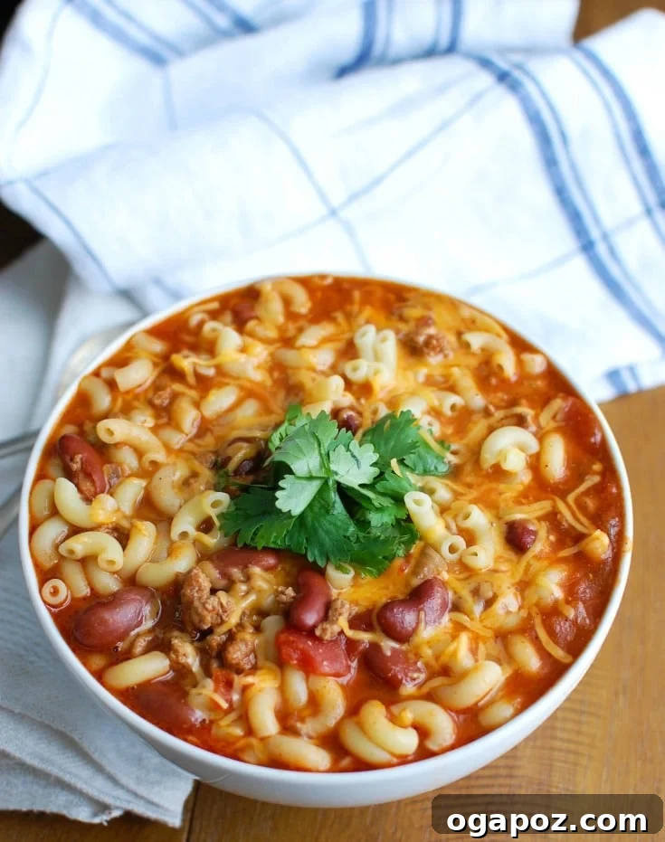 Hearty Slow Cooker Turkey Chili Mac and Cheese 2 A close-up of Crock-Pot® Turkey Chili Mac and Cheese, showcasing the rich, creamy texture and hearty ingredients. Perfect for dinner or game day comfort.