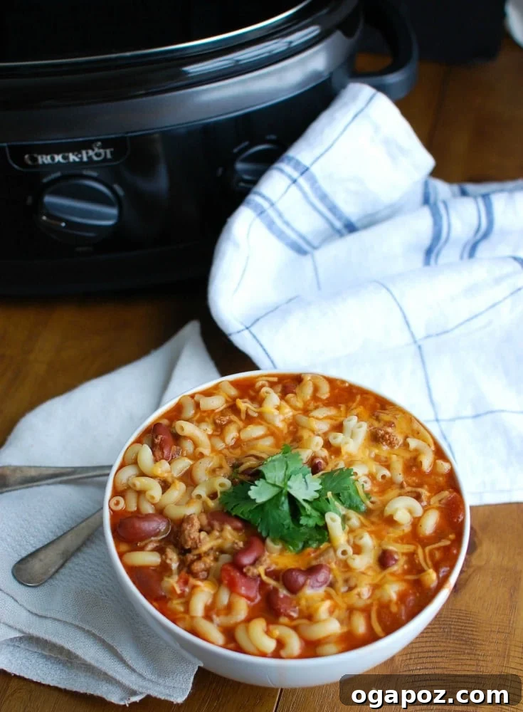 Hearty Slow Cooker Turkey Chili Mac and Cheese 6 A vibrant and appealing photo of the finished Crock-Pot® Turkey Chili Mac and Cheese, garnished and ready to serve.