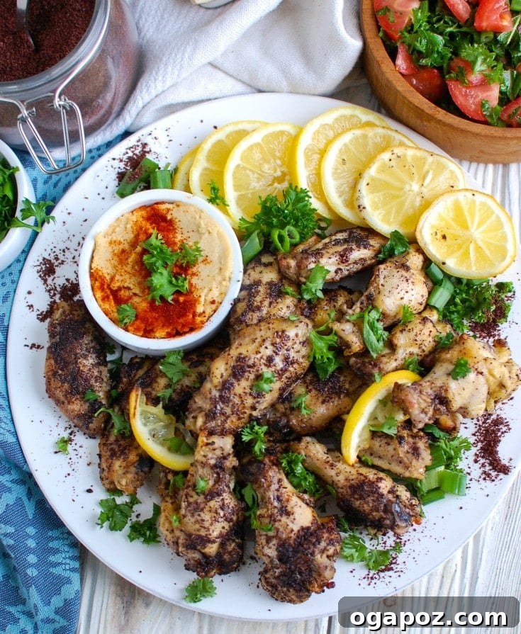 Zesty Sumac Lemon Wings 3 A vibrant selection of fresh ingredients including sumac spice, lemons, olive oil, garlic, and raw chicken wings ready for marinating.