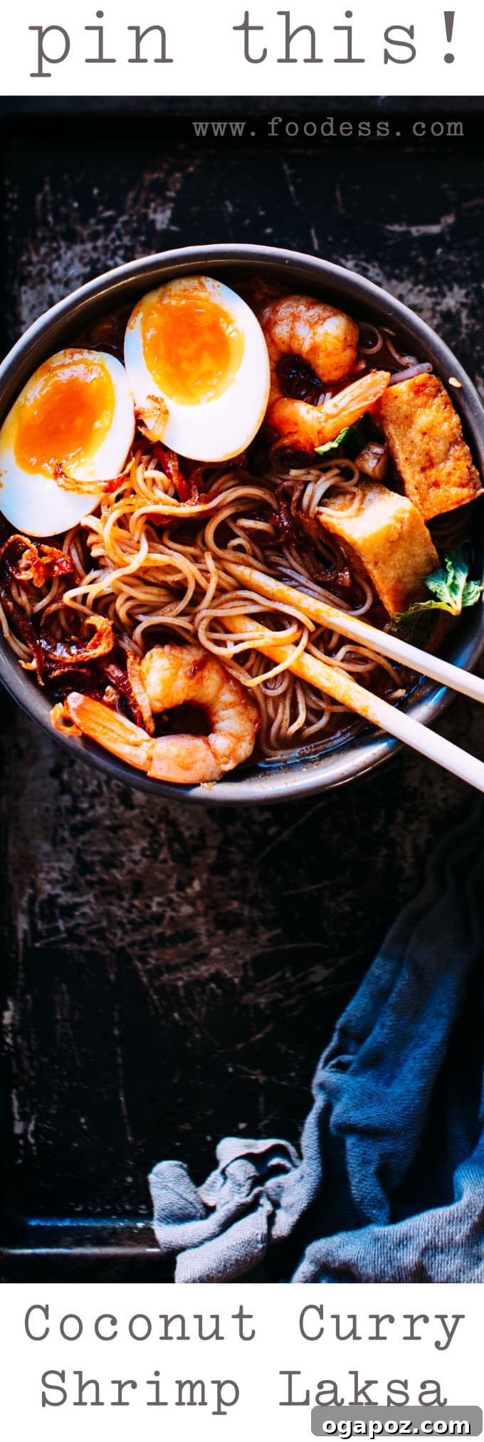 A beautifully composed bowl of Coconut Shrimp Laksa, garnished with fresh herbs.