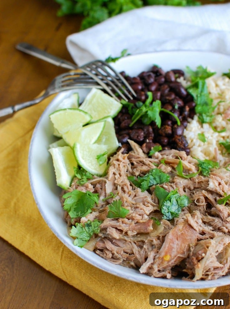 Slow Cooker Mojo Pork Rice Bowls 2 Slow Cooker Cuban Pork Rice Bowls with forks, showcasing the tender pulled pork, rice, and fresh toppings.