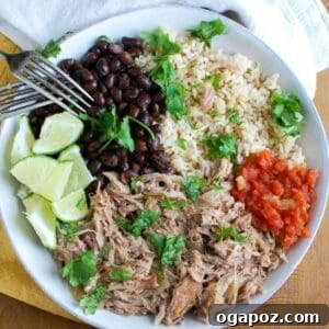 Slow Cooker Mojo Pork Rice Bowls 6 A vibrant bowl of Slow Cooker Cuban Pork Rice Bowls, topped with fresh ingredients.