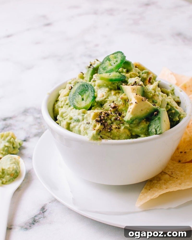 Perfectly Simple Guacamole 2 A vibrant bowl of homemade chunky guacamole, ready to be enjoyed.