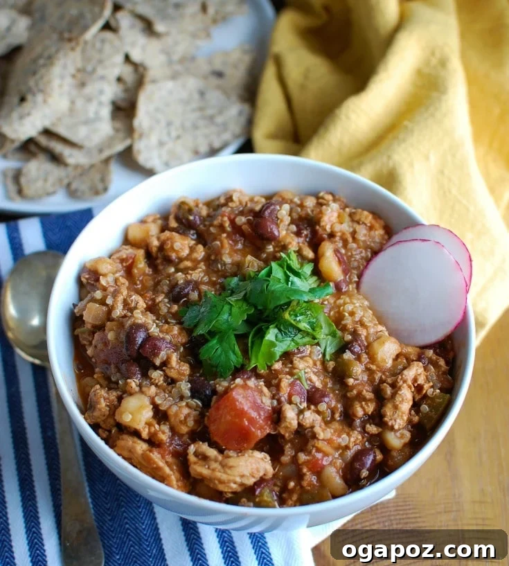 Hearty Slow Cooker Turkey Quinoa Chili 4 A top-down view of Slow Cooker Turkey Quinoa Chili in a bowl, showing the various ingredients and rich red color.