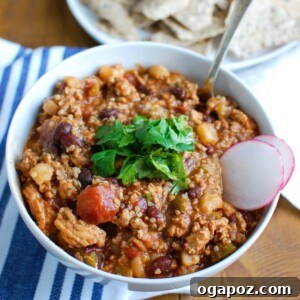 Slow Cooker Turkey Quinoa Chili is hearty, healthy and cooks all day in your crockpot! You can come home to a warm, comforting bowl of chili without spending time in the kitchen. This is perfect for dinner or watching football