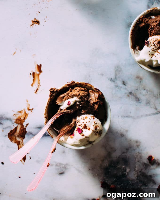 Whip Up Dreamy Chocolate Mousse in Your Blender 4 Individually portioned blender chocolate mousse served in clear glasses, topped with a generous swirl of whipped cream.