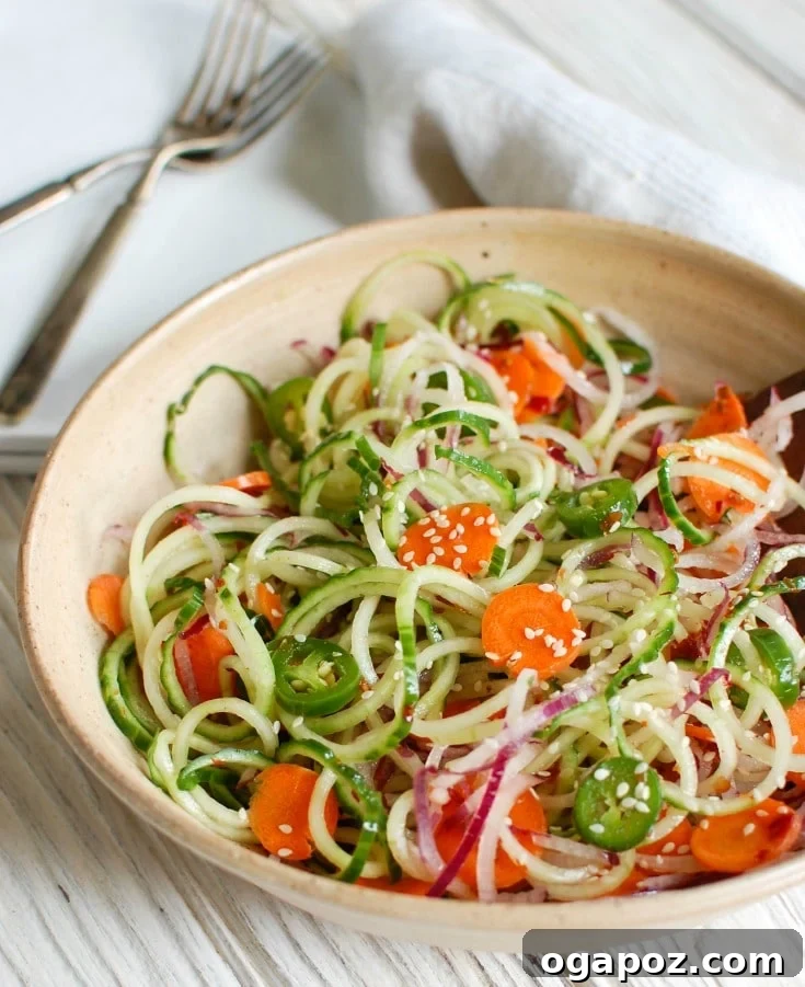 Cool Sesame Cucumber Noodles 2 Asian Cucumber Noodle Salad is a light and healthy salad or side dish. Cucumber and red onion noodles, carrots and jalapeños are tossed with a light Asian dressing.