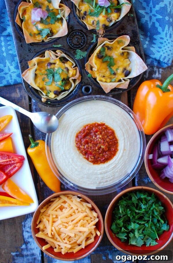 Fiesta Hummus Wonton Cups 5 Baked Southwestern Hummus Wonton Cups garnished with fresh cilantro, ready to be enjoyed as a vibrant appetizer.
