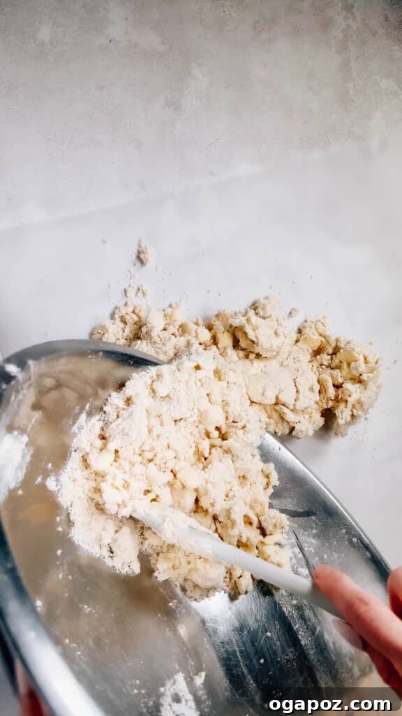 Foolproof Pie Crust You Can Make By Hand 11 Dumping the shaggy dough mixture onto a sheet of parchment paper.