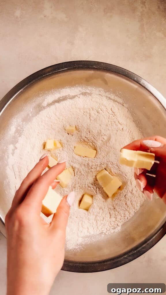 Foolproof Pie Crust You Can Make By Hand 5 Adding the first portion of cold butter to the flour mixture.