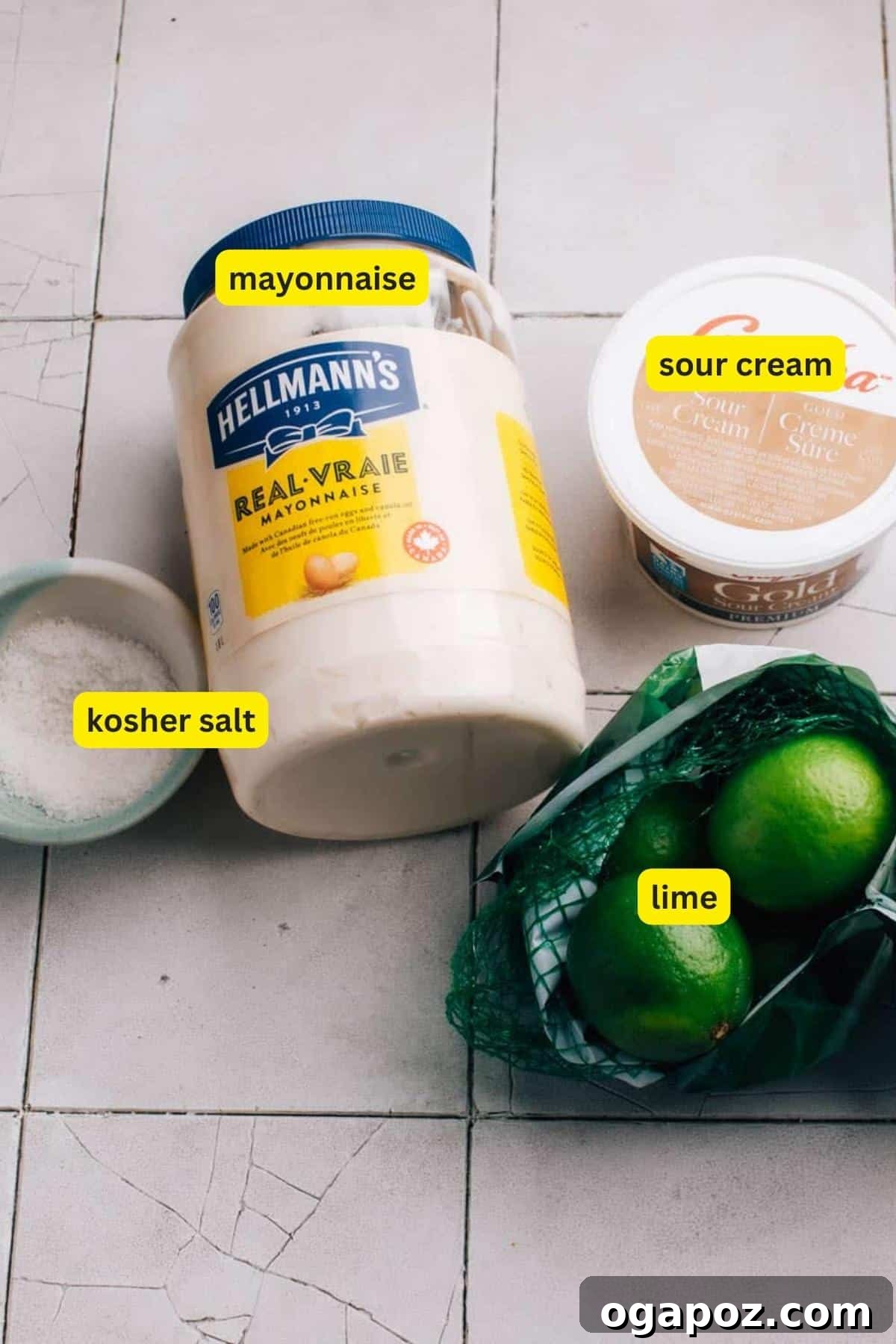 Vibrant Cilantro-Lime Drizzle 3 Ingredients for Cilantro Lime Crema placed on a kitchen countertop including mayonnaise, sour cream, kosher salt, and fresh limes.