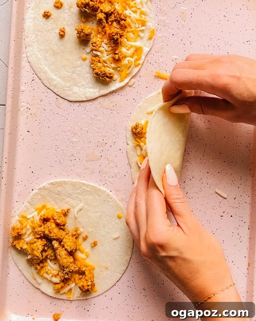 Delicious tacos being assembled with seasoned ground chicken, fresh toppings, and vibrant garnishes, showcasing the perfect meal.