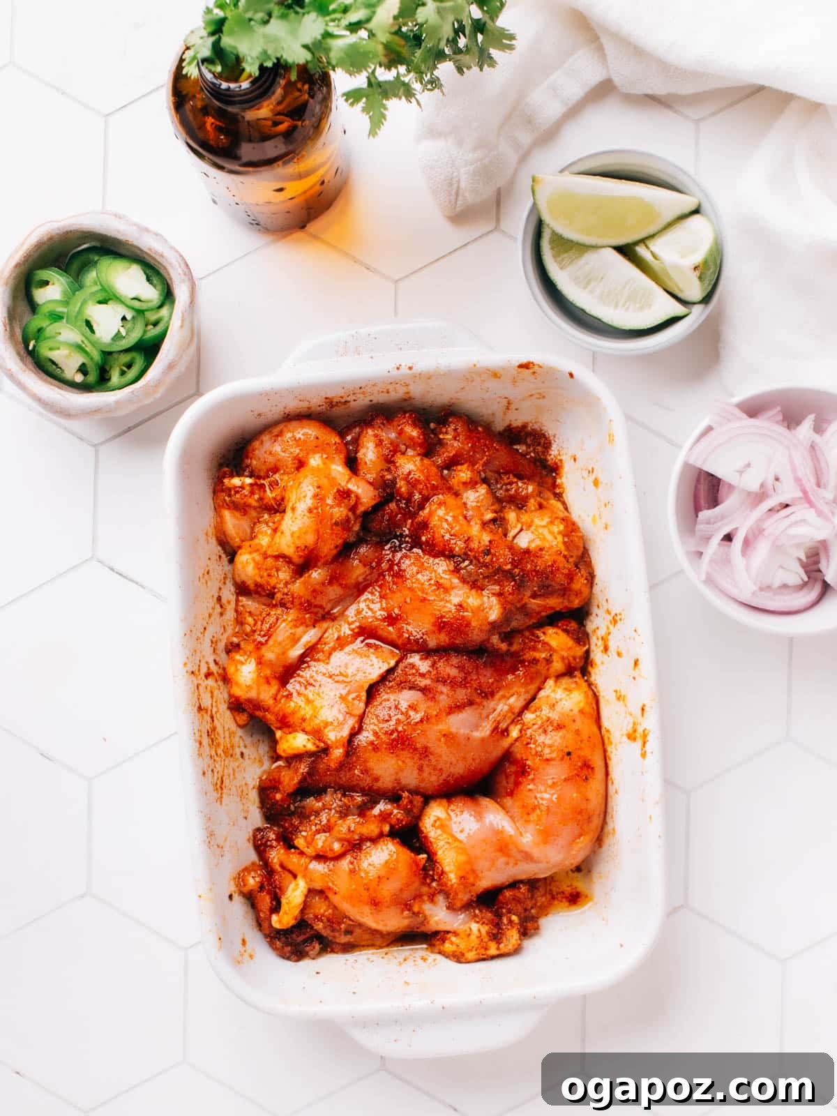 Authentic Chicken Street Tacos 9 The marinated chicken thighs are left to rest at room temperature for 30 minutes. There are individual bowls of sliced jalapenos, onions, and limes beside the chicken bowl.