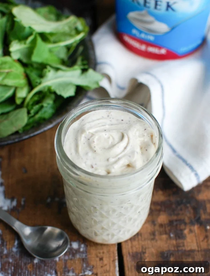 Creamy Tahini Yogurt Dressing 6 Tahini Yogurt Dressing in a jar next to a tub of yogurt, emphasizing its key ingredient