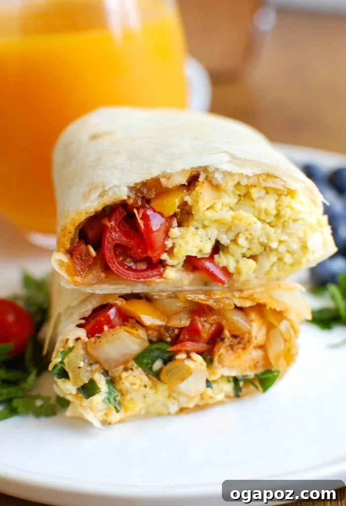 Stacked vegetarian breakfast egg burritos, showcasing the golden tortilla and the hint of savory filling within, ready to be enjoyed.