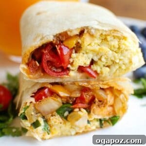Vegetarian Breakfast Egg Burritos prepared and ready to eat, showing a cross-section of the filling.
