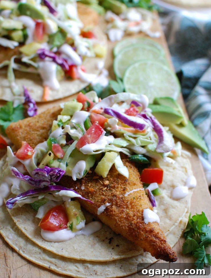 Tropical Fish Tacos with Sweet Heat Pineapple Salsa 2 Delicious Easy Fish Tacos with Spicy Pineapple Salsa, topped with fresh cilantro and a creamy slaw, served on warm tortillas.