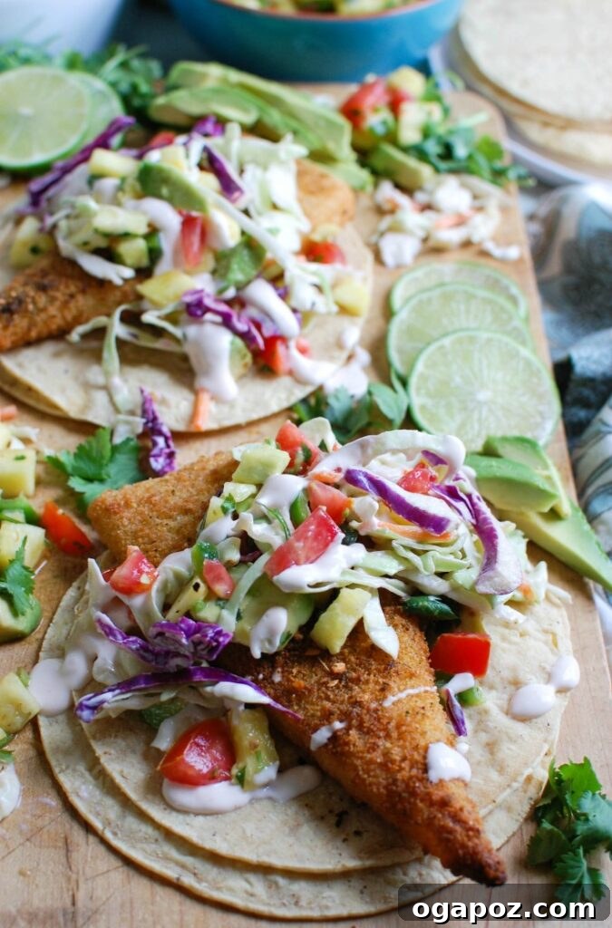 Tropical Fish Tacos with Sweet Heat Pineapple Salsa 3 Close-up of freshly prepared Easy Fish Tacos with Spicy Pineapple Salsa, showcasing the crispy cod and vibrant toppings.