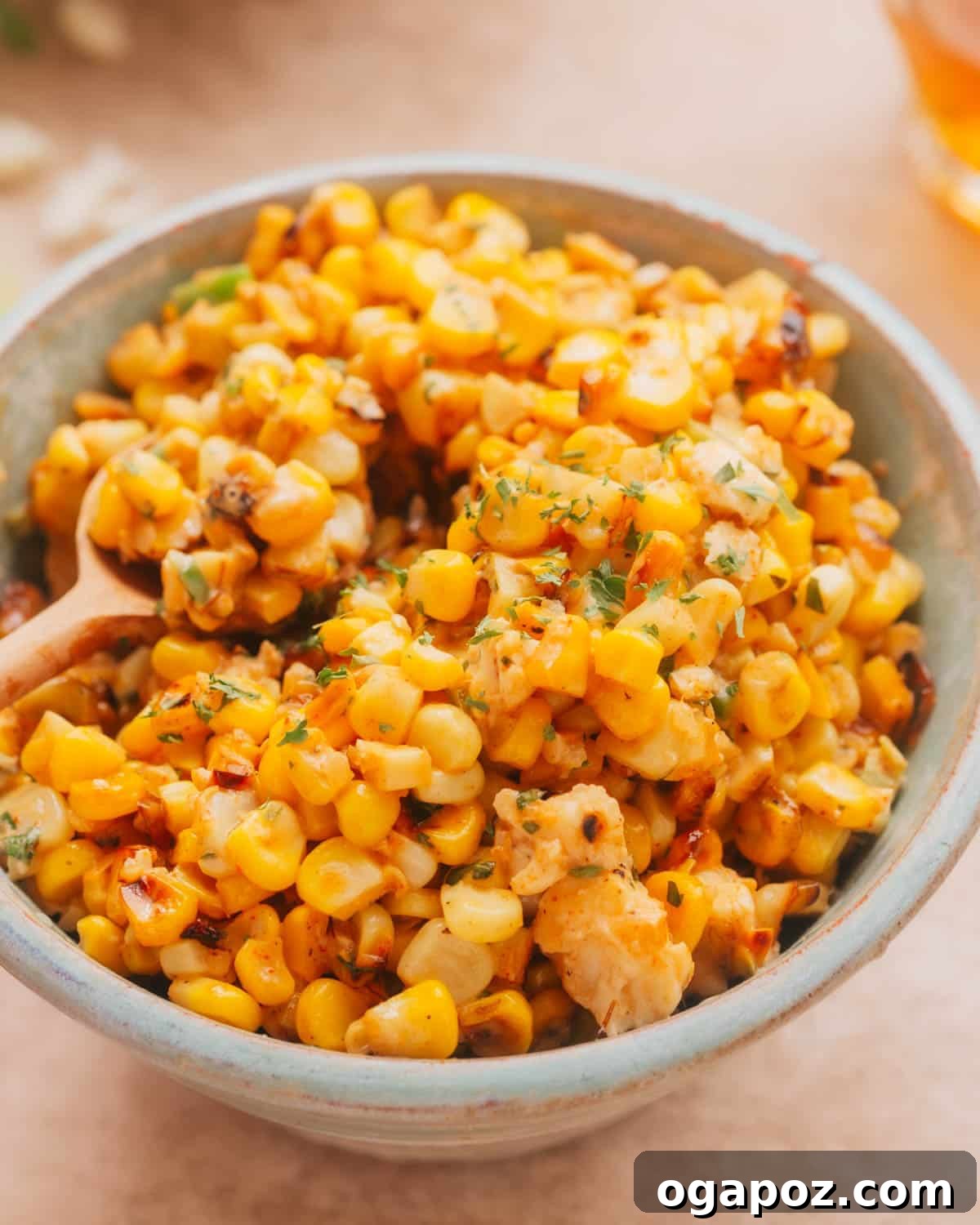 A vibrant bowl of Mexican Street Corn Salad (Esquites) garnished with fresh cilantro, ready to be served.