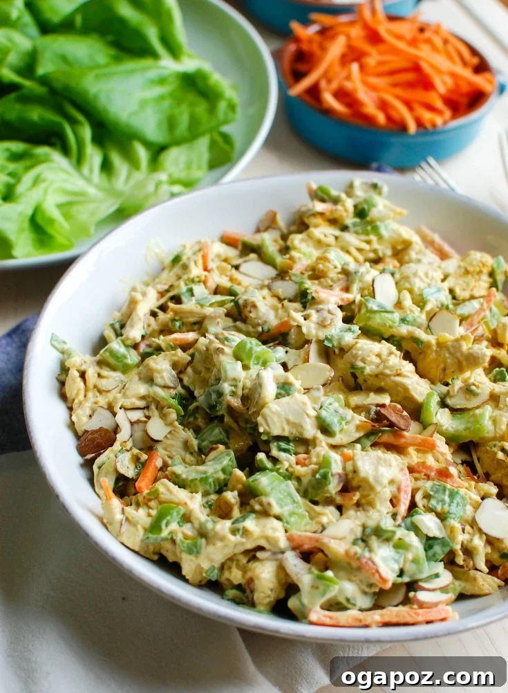 Effortless Curried Chicken Salad 2 Simple Curry Chicken Salad with a creamy, golden dressing, mixed with fresh vegetables and golden raisins, served on a plate.