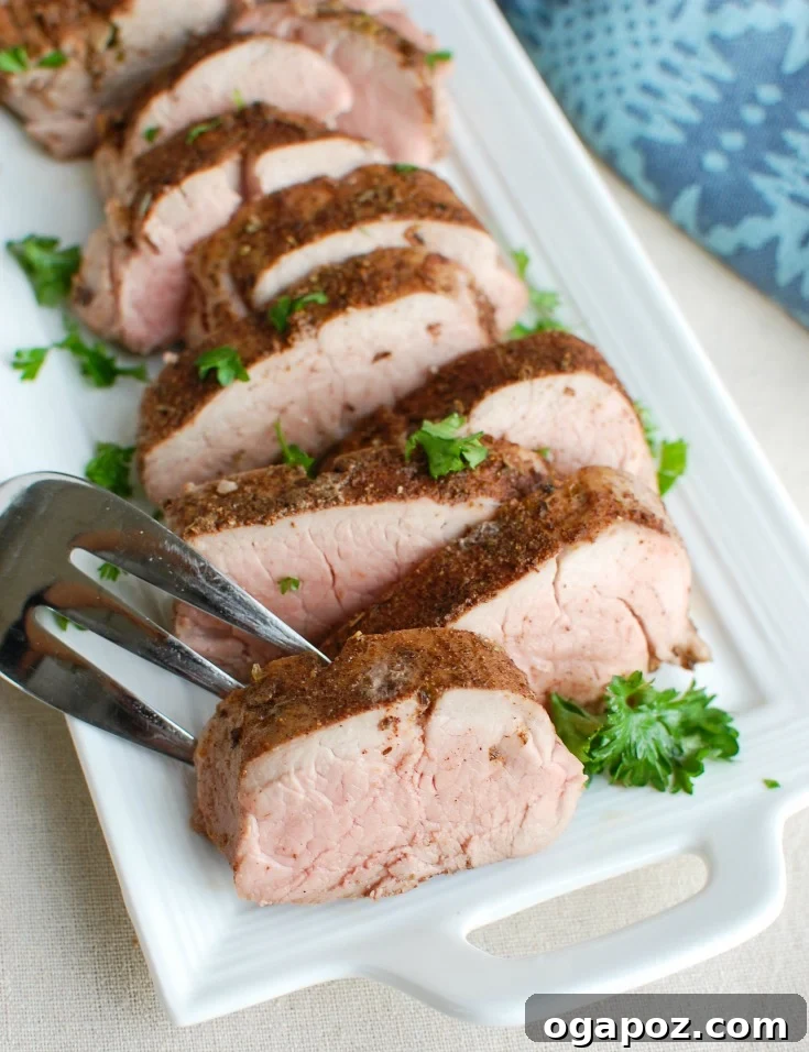 Sun-Kissed Mediterranean Pork Tenderloin 6 A slice of Mediterranean Baked Pork Tenderloin on a fork.