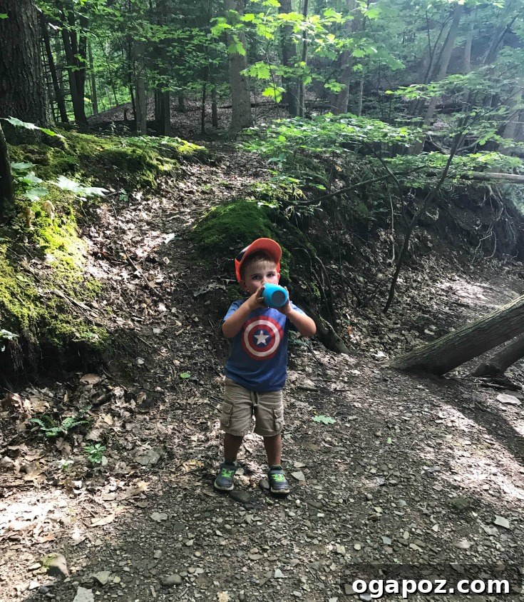 Unlock Healthy Hydration with Gululu 3 Kids enjoying an adventurous hike with their Gululu smart water bottles.