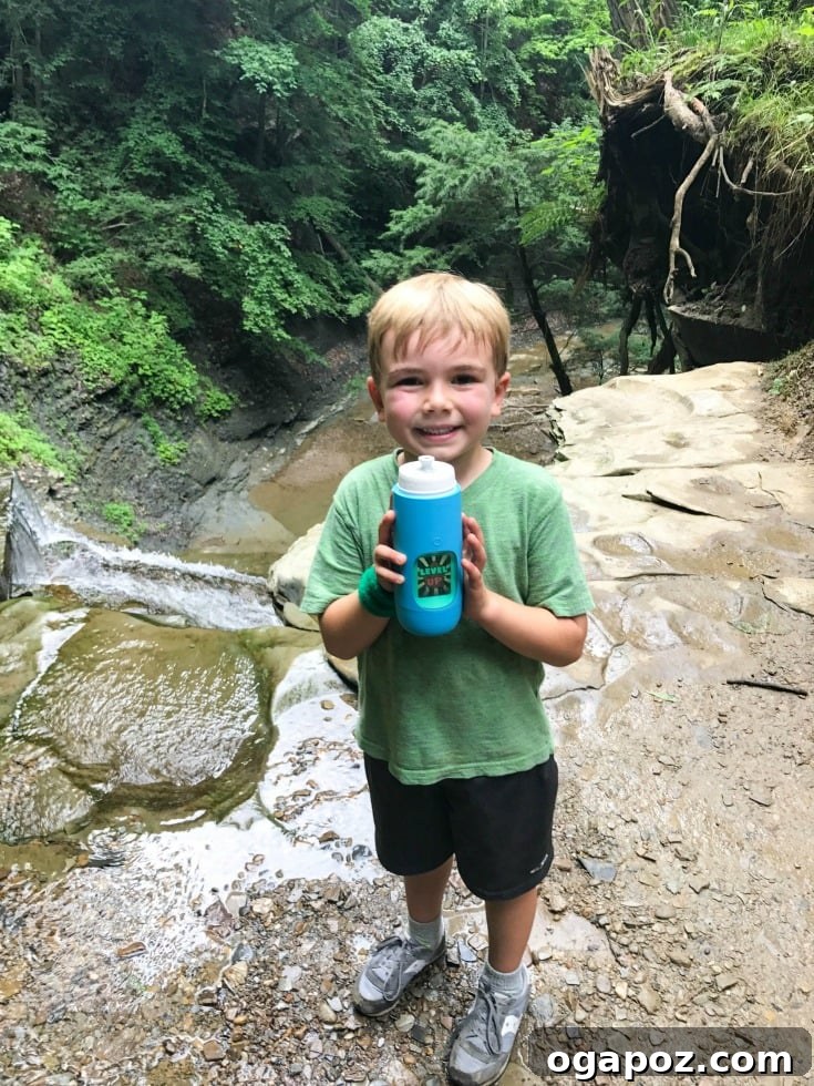 Unlock Healthy Hydration with Gululu 7 A child playing outdoors with their Gululu smart water bottle.