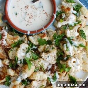 Za'atar Roasted Cauliflower with Yogurt Tahini Sauce in a serving bowl.