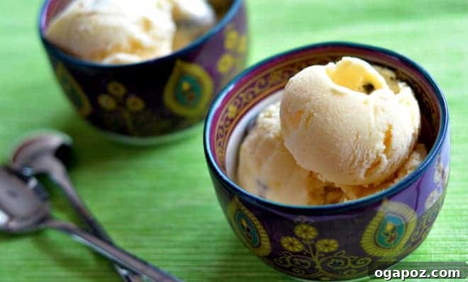 A vibrant golden-orange mango kulfi, ready to be served as a refreshing Indian dessert.