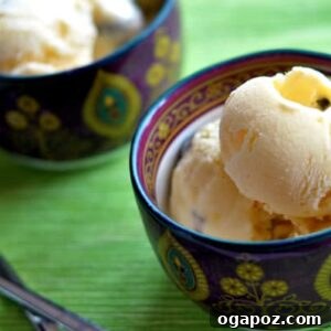 Close-up image of a perfectly set Mango Kulfi in a traditional mold, garnished with a sprinkle of chopped pistachios.