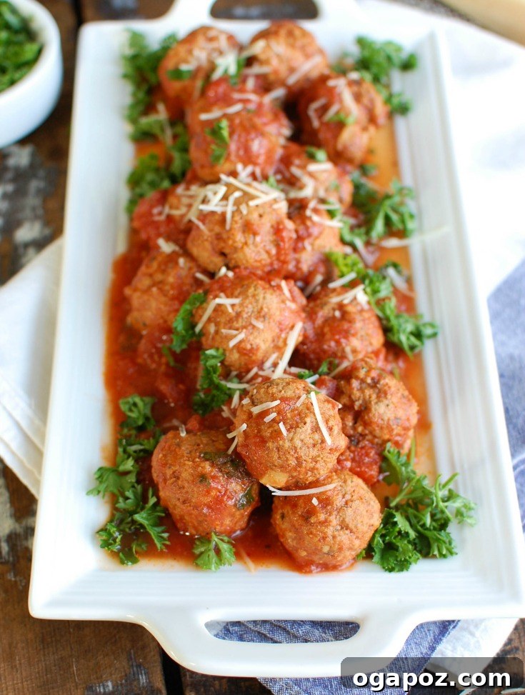 Tender Slow-Cooked Veal Meatballs 3 Plated Slow Cooker Veal Meatballs with fresh parsley.