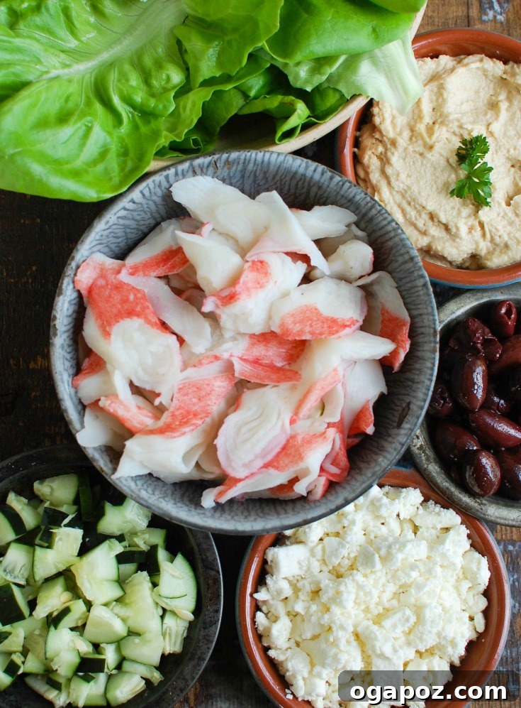 Refreshing Mediterranean Surimi Wraps 5 Assortment of fresh ingredients for Mediterranean Surimi Lettuce Wraps, including surimi, vegetables, and dips.