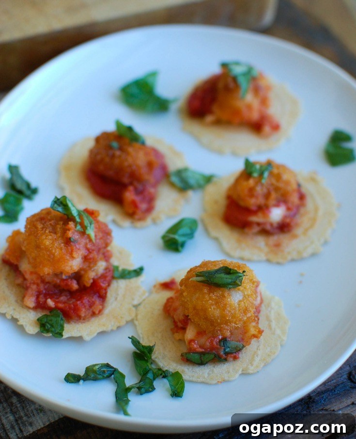 Crispy Shrimp Caprese Bites 5 A beautifully presented skillet of Tomato Basil Mozzarella Popcorn Shrimp Bites, with fresh basil leaves for garnish, ready to be enjoyed.