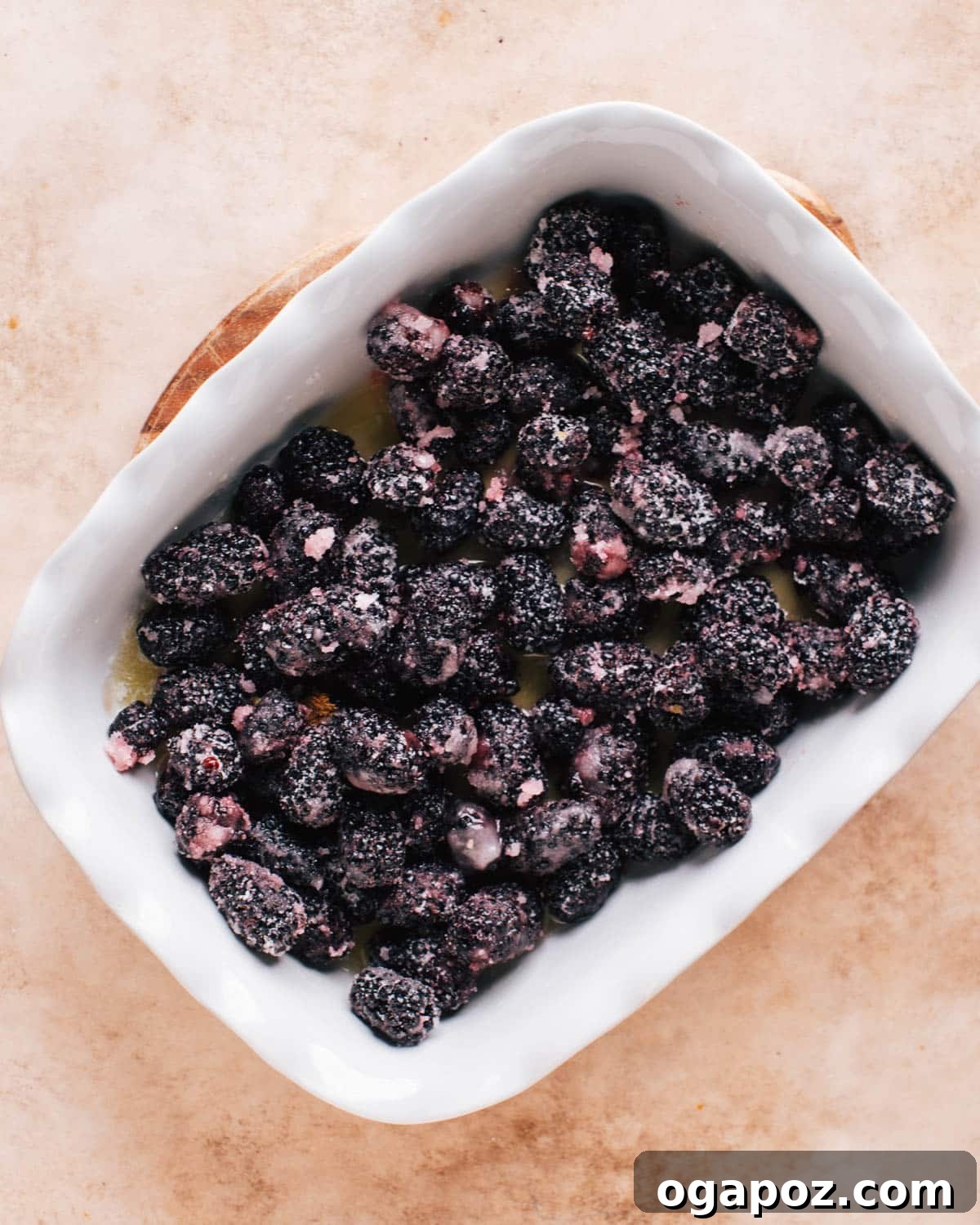 Homestyle Blackberry Cobbler 8 A white baking dish filled with freshly made blackberry filling to make blackberry cobbler.