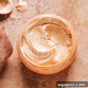 Creamy Baja Sauce for fish tacos in a bowl with ingredients around it