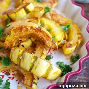 A serving of roasted delicata squash with Parmesan cheese.