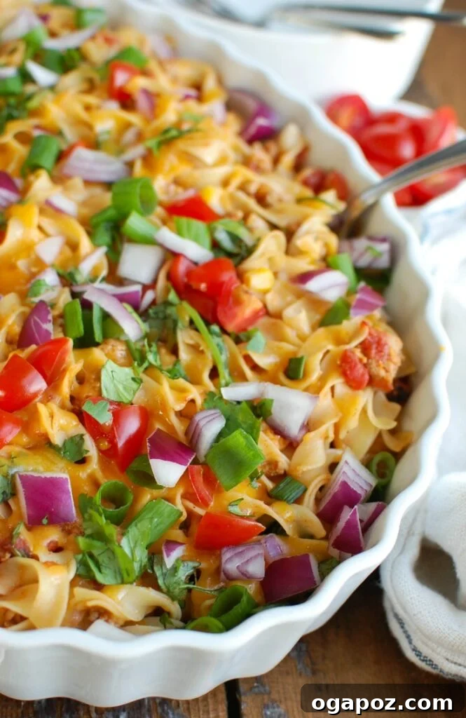 6 Noodle Hacks to Elevate Your Weekly Meals 3 Easy Mexican Noodle Casserole, a colorful dish with No Yolks Noodles, vegetables, ground turkey, spices, and cheese.